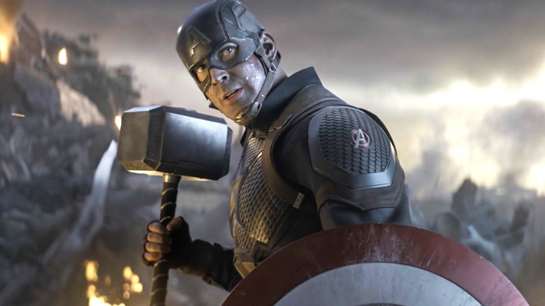 Chris Evans as Captain America holding his shield and Mjolnir in Avengers: Endgame