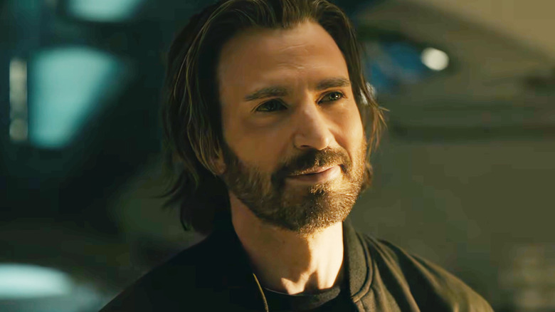 Chris Evans as Steve Rogers standing inside a spaceship and smiling at someone off-screen in Avengers: Doomsday