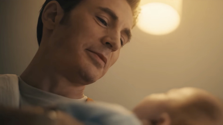 Chris Evans as Steve Rogers smiling down at his baby in Avengers: Doomsday