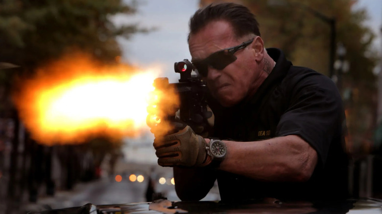 Arnold Schwarzenegger's Breacher firing a machine gun through a sunroof in Sabotage.