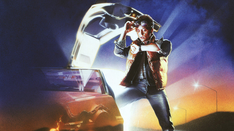 Marty McFly standing next to the DeLorean looking at his watch