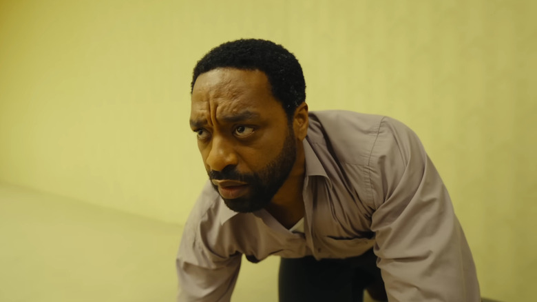 Chiwetel Ejiofor as Clark kneeling down after just entering the Backrooms in Backrooms