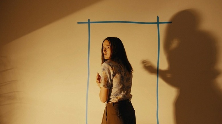 Mary in front of a tape doorway in Backrooms
