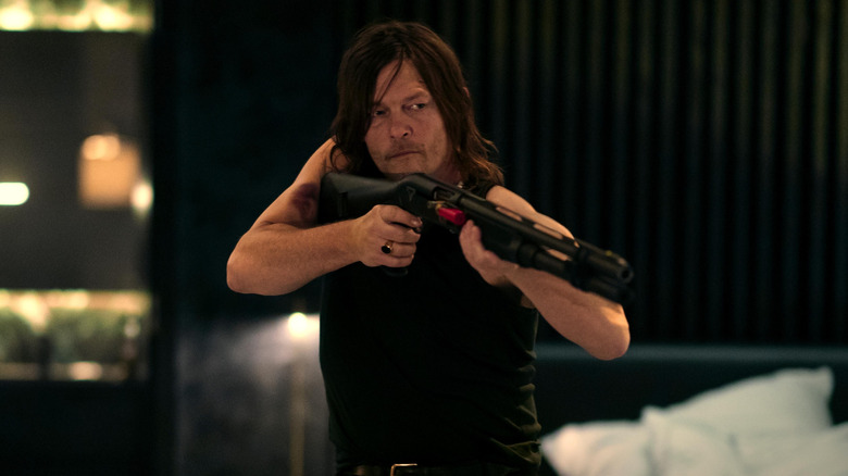 Norman Redos in the role of Daniel holds his rifle in his room in his hotel from the world of John Wake: a ballet dancer