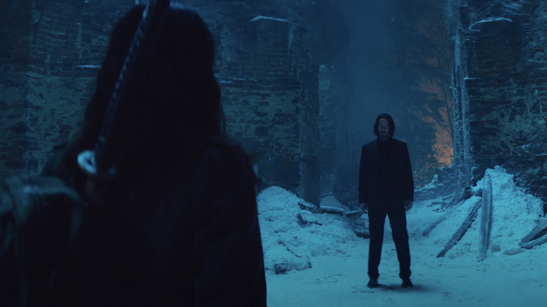John Wick stands in the snow, ready to face off against Eve in Ballerina
