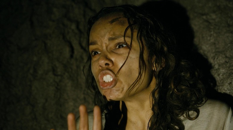 Georgina Campbell as Tess in the tunnel lit by a barbarian flashlight