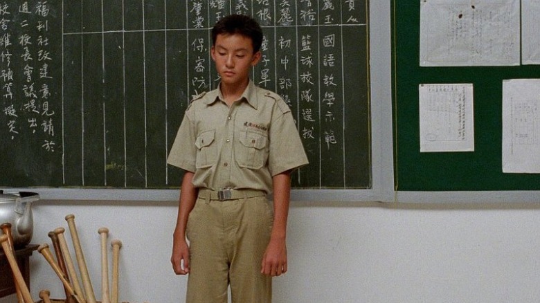 Chang Chen as Hsiao Si'r standing in front of blackboard in A Brighter Summer Day