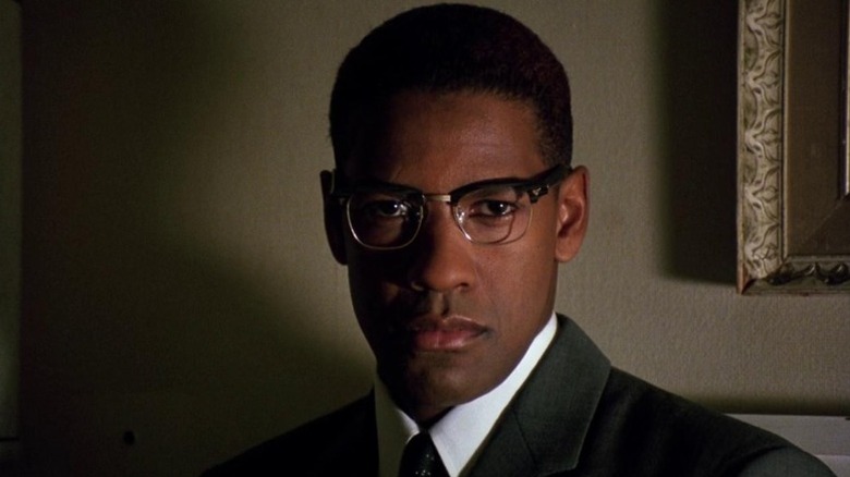 Denzel Washington as Malcolm X looking square at the camera in Malcolm X