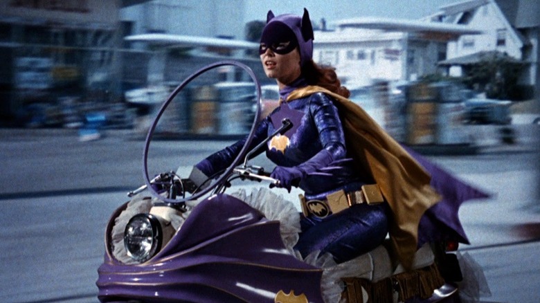 Yvonne Craig as Batgirl riding a motorcycle