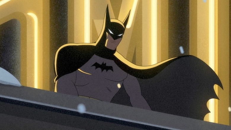 Batman standing beneath a neon sign on a rooftop in Batman: Caped Crusader