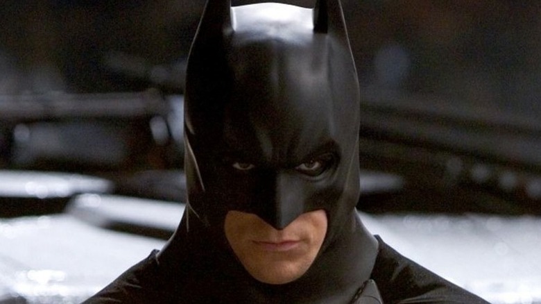 Christian Bale as Batman in cowl and cape