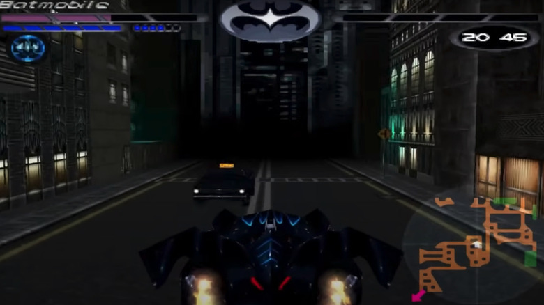 The Batmobile drives down a Gotham street in the Batman & Robin video game