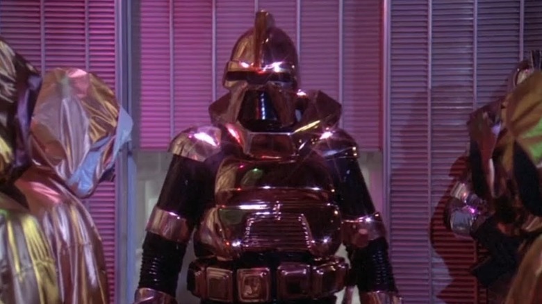 Battlestar Galactica (1978) - Cylon Centurion surrounded by Cylon civilians