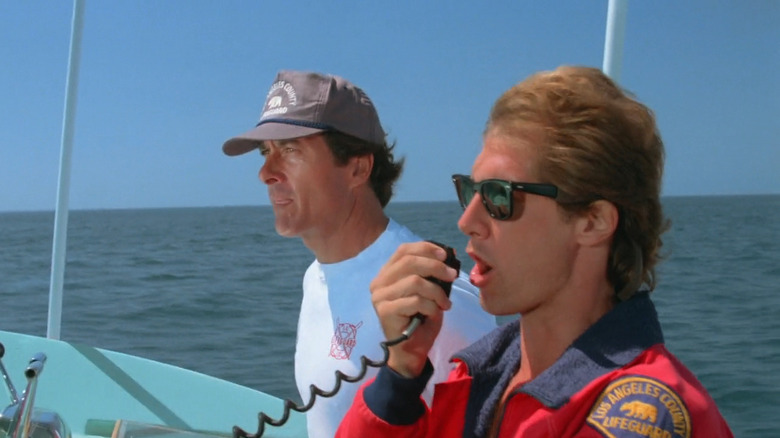 Jim (Gregory J. Barnett) driving boat while Craig (Parker Stevenson) talks on radio in Baywatch