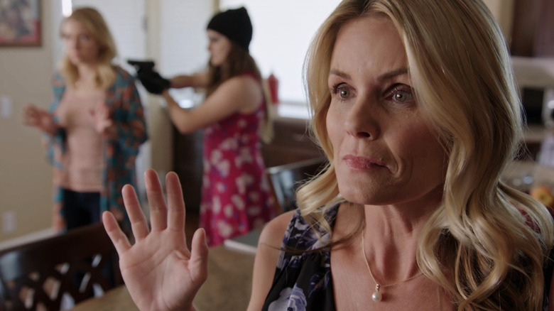 Lisa (Kelly Packard) raises hands in Family Vanished