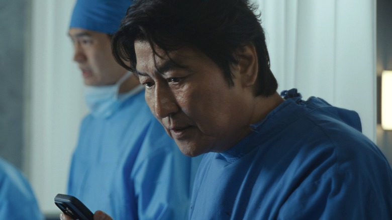 Dr. Kim talks to his wife on the phone after botching a surgery in Beef season 2