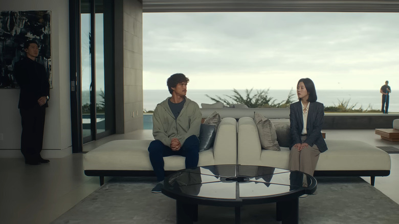 Charles Melton as Austin Davis sitting with hands clenches in Beef Season 2