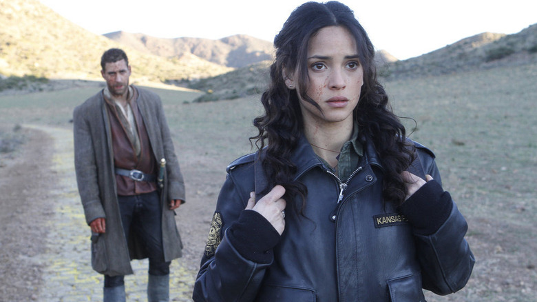 Adria Arjona as Dorothy Gale, with Lucas - aka Scarecrow - in Emerald City on NBC