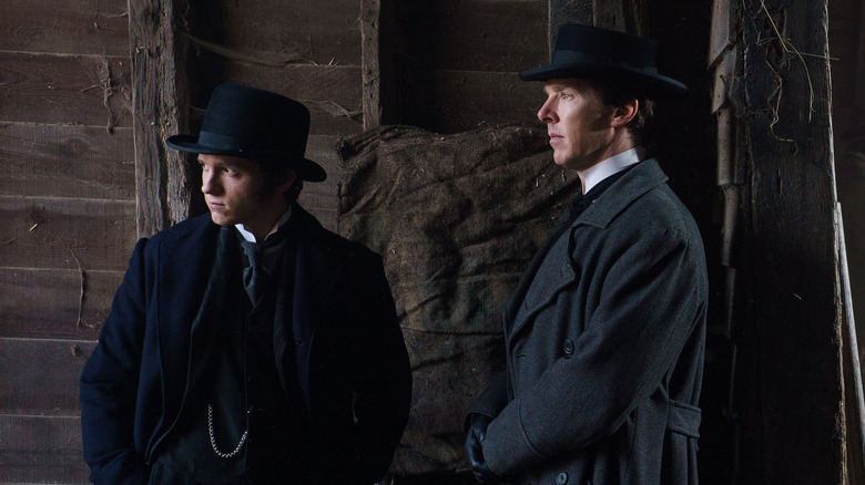 Tom Holland as Samuel Insull standing next to Benedict Cumberbatch as Thomas Edison in The Current War