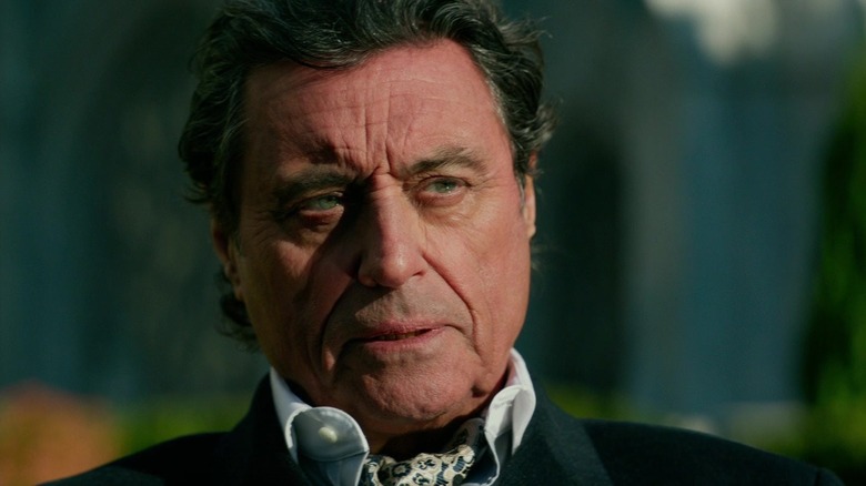 Old Winston sitting outside in John Wick: Chapter 2