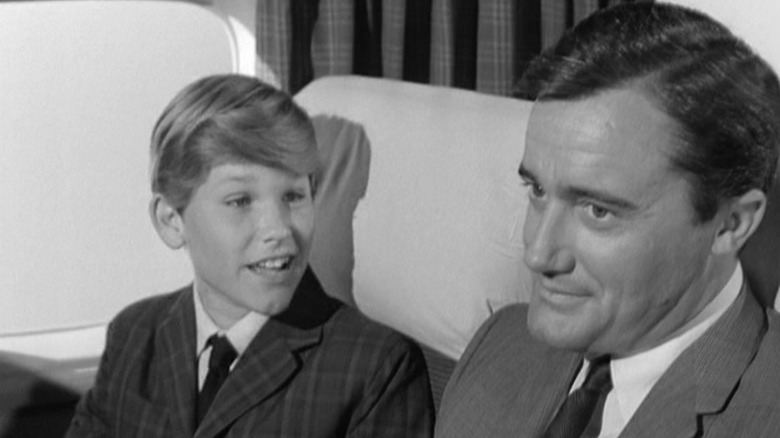 Christopher Larson and Napoleon Solo sitting in a car together in The Man From U.N.C.L.E.