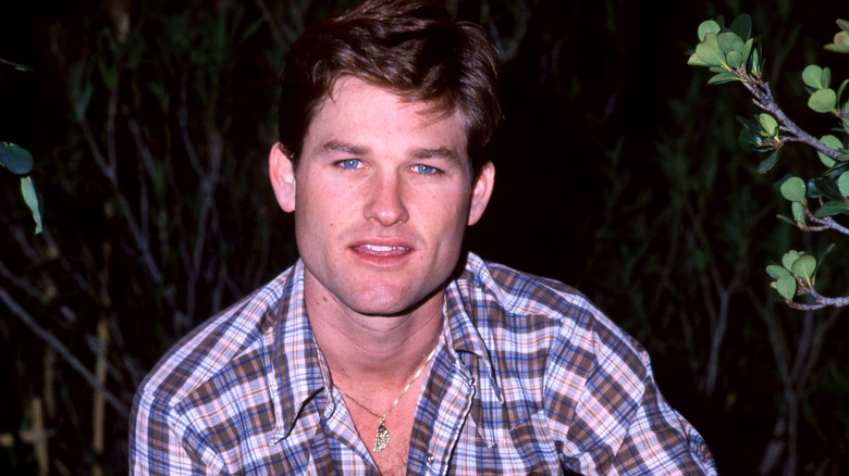 Kurt Russell in a plaid shirt