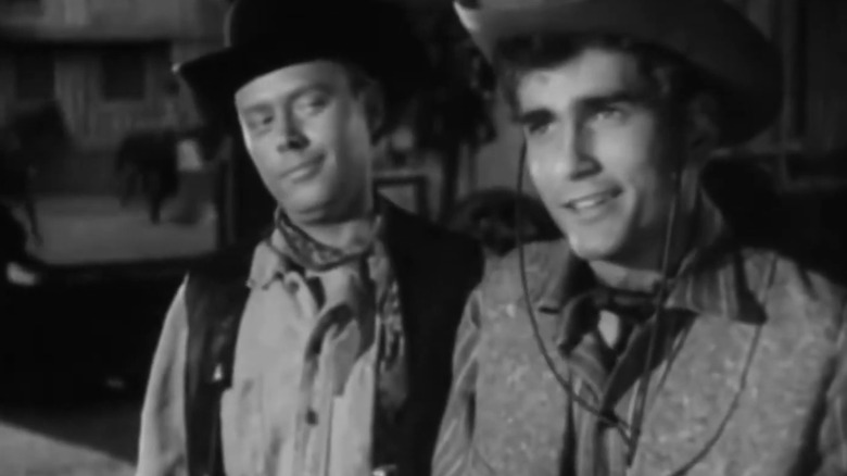 Michael Landon's Sandy stands beside Robert Crosson's Al in The Restless Gun