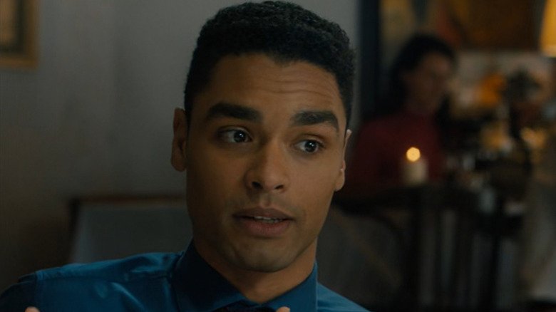 Rege-Jean Page as Robert Purvell sitting at a dinner table in Survivor (2015)