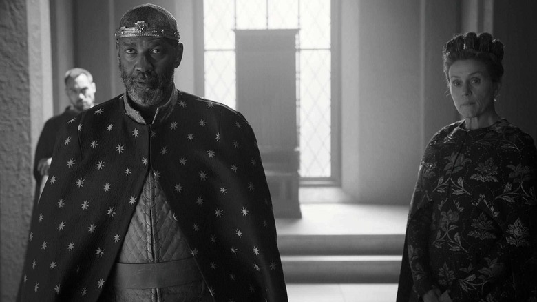 Macbeth and Lady Macbeth looking tensely at someone in The Tragedy of Macbeth