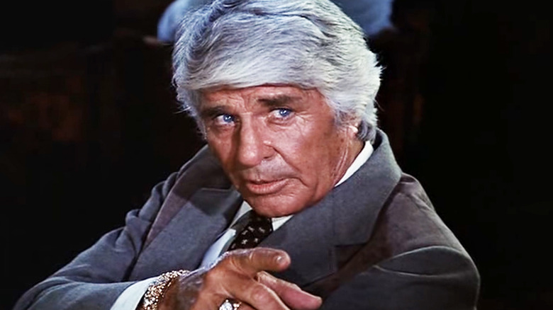 Jim Davis' Jock Ewing points towards camera in Dallas