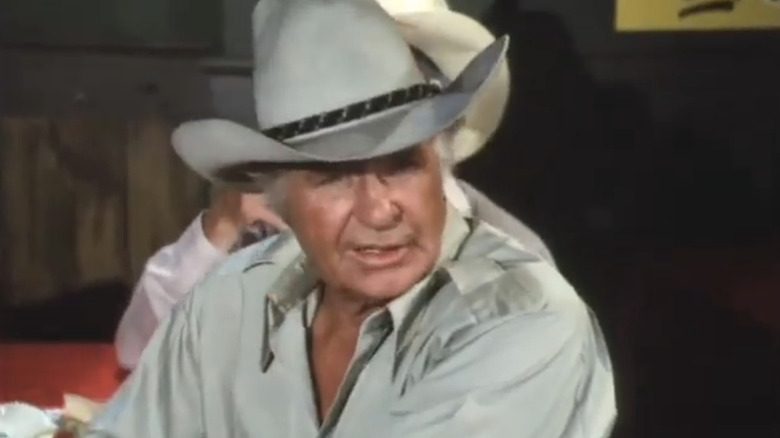 Jim Davis' Jock Ewing sits in a bar in Dallas