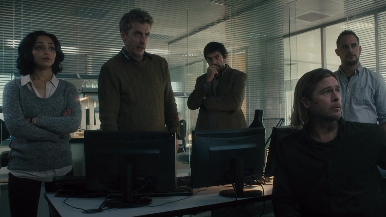 The WHO medical team and Gerry Lane sitting in an office in World War Z
