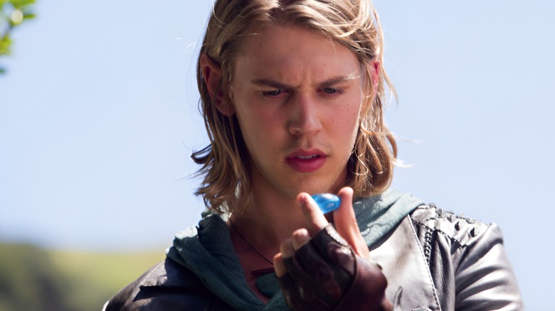 Wil looks at a blue stone with a confused expression in The Shannara Chronicles