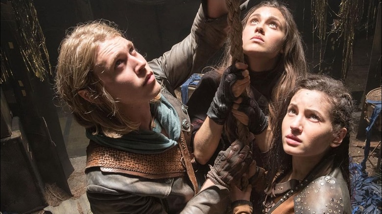 Wil, Amberle, and Eretria pull on a rope together in The Shannara Chronicles
