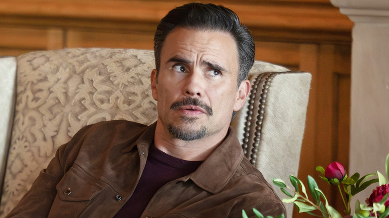 Juan Pablo Raba's Joaquin Reyes sitting in a chair in Dutton Ranch