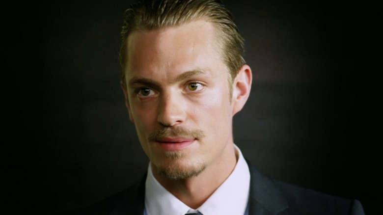 Joel Kinnaman's Skyler is seen in closeup wearing a suit in The Darkest Hour