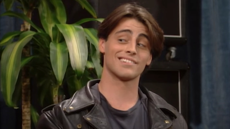 Vinnie in a leather jacket smiling on Married... with Children
