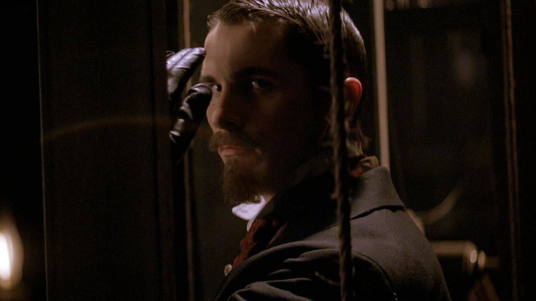 Christian Bale as Alfred Borden saluting menacingly in The Prestige