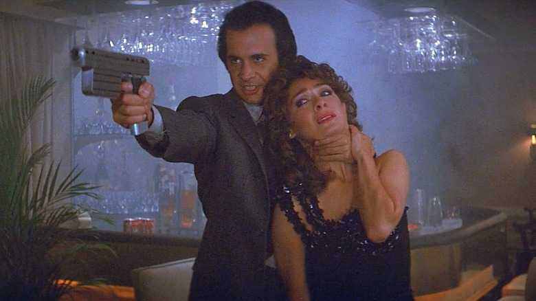 Dr. Luther holding a space gun and a hostage in Runaway