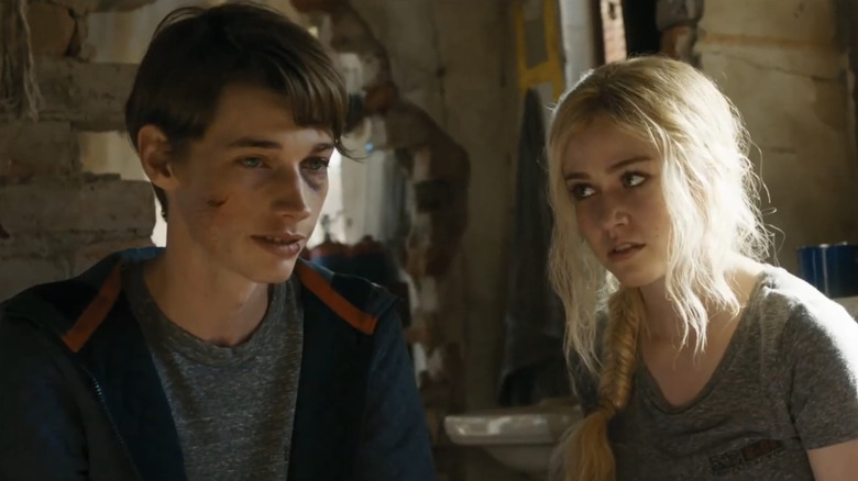 Jacob Lofland's Aris stands alongside Katherine McNamara's Sonya in Maze Runner The Scorch Trials