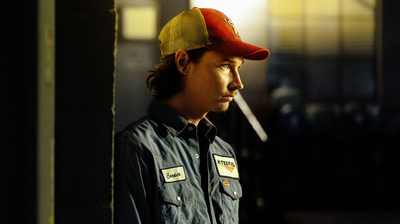 Jacob Lofland's Cooper Norris stands under a bright light at night in Landman