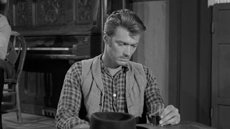 Clint Eastwood's John Lucas sits looking sad in a saloon in Death Valley Days