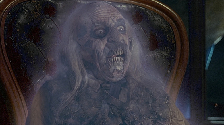 John Astin as The Judge sitting in a chair in The Frighteners