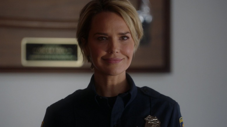 Arielle Kebbel as Lucy Donato smiling in her uniforn in 9-1-1