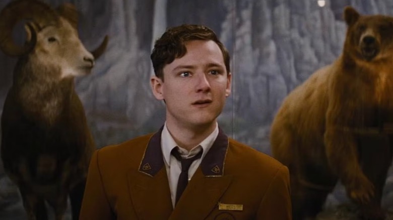 Lewis Pullman's Miles Miller wearing hotel uniform in Bad Times at the El Royale