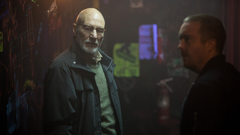 Patrick Stewart as Darcy and Macon Blair as Gabe standing in a hallway in Green Room