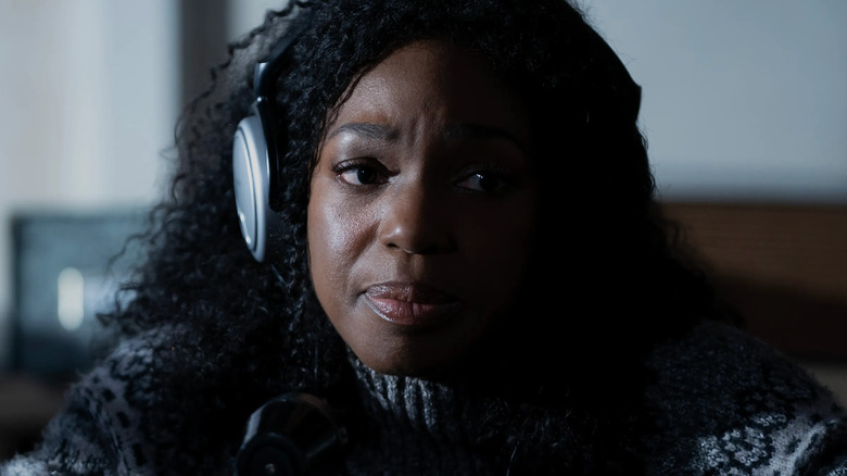 Enuka Okuma as Teri Rogers-Collins wearing headphones in Paradise