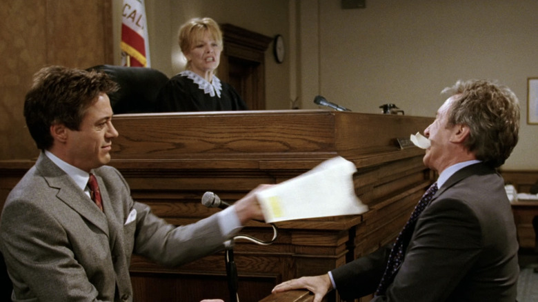 Dr. Marcus Kozak van Robert Downey Jr. haalt een stuk papier uit de mond van David Douglas van Tim Allen in The Shaggy Dog