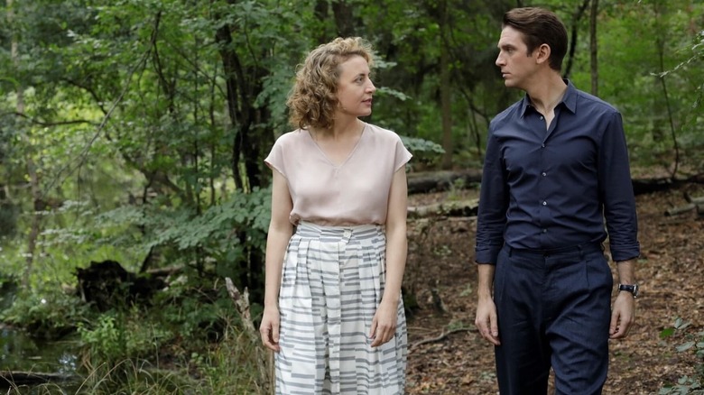 Alma and Tom waling through the woods in I'm Your Man
