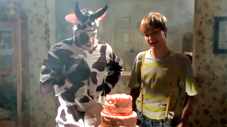 Expressive cow and Farid stand on a birthday cake in Farid: The offer